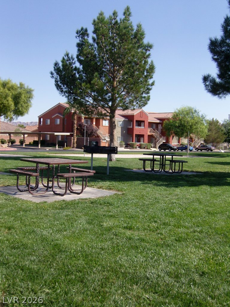 4730 East Craig Road, Unit 1073 Las Vegas, NV 89115 - Photo 16 of 18 Lush grassy common areas surround the residential structures, offering picnic spots under mature shade trees.