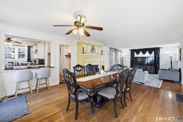 a view of a dining room with furniture and wooden floor