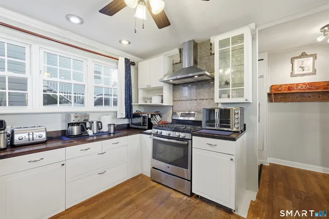 a kitchen with stainless steel appliances a sink stove and cabinets
