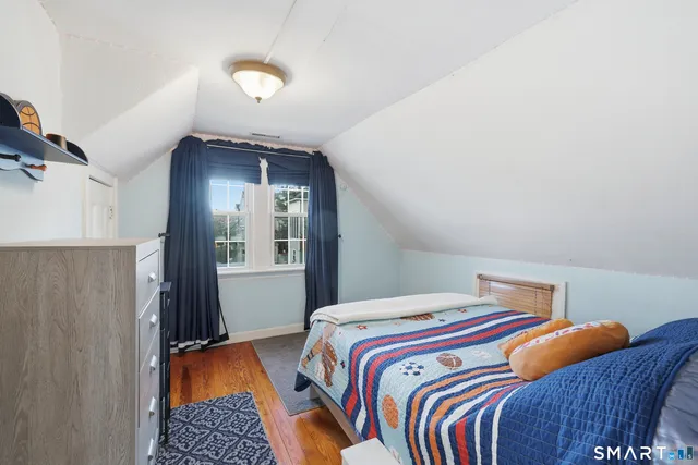 a bedroom with a bed and lamp