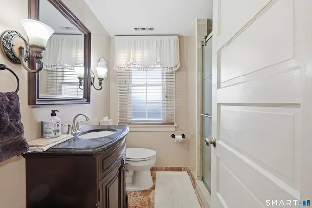 a bathroom with a sink toilet and shower