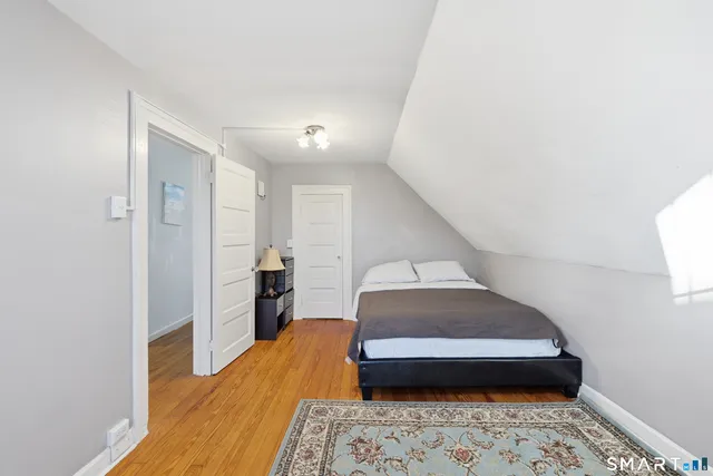 a bedroom with a bed and a view of bathroom