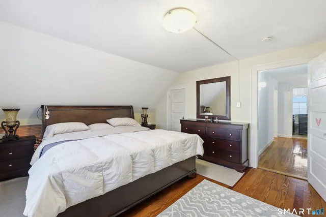 a bedroom with a bed and a mirror