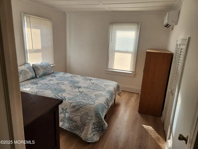 a bedroom with a bed and a mirror on dresser