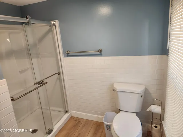 a bathroom with a toilet and a shower