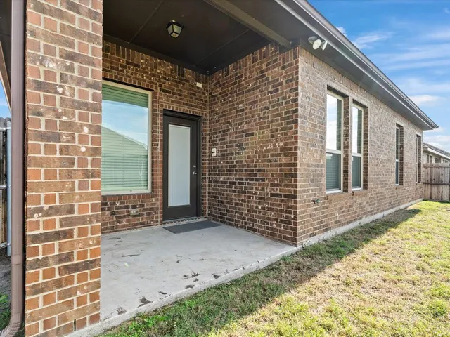 a view of a brick house with many windows