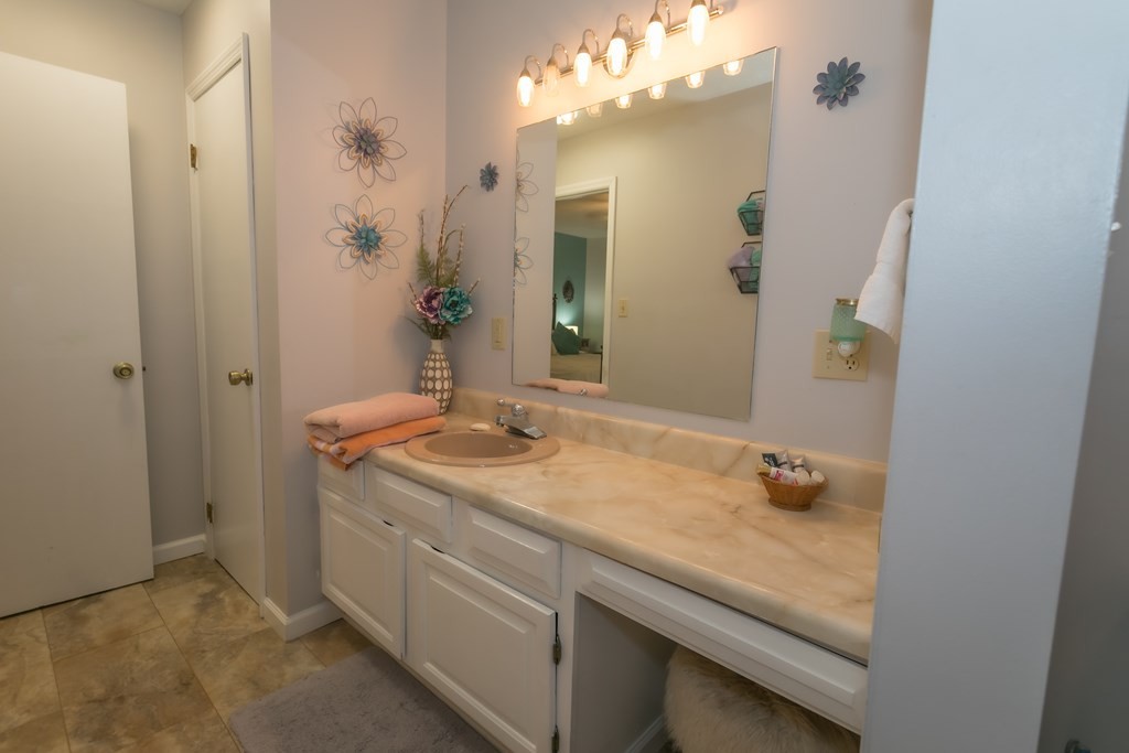 3108 Fortenberry Road Kodak, TN 37764 - Photo 19 of 47 a bathroom with a granite countertop sink and a mirror