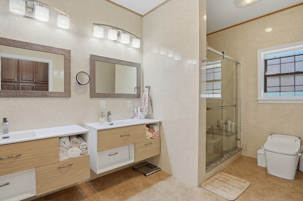 112 Pineland Avenue Worcester, MA 01604 - Photo 33 of 38 a spacious bathroom with a double vanity sink a mirror and a toilet