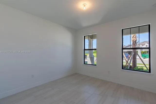 an empty room with windows and closet