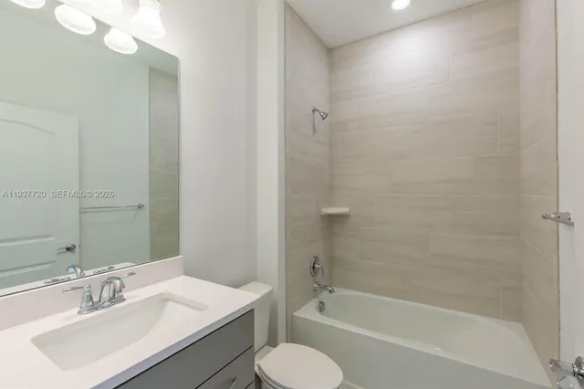 a bathroom with a sink toilet tub and shower