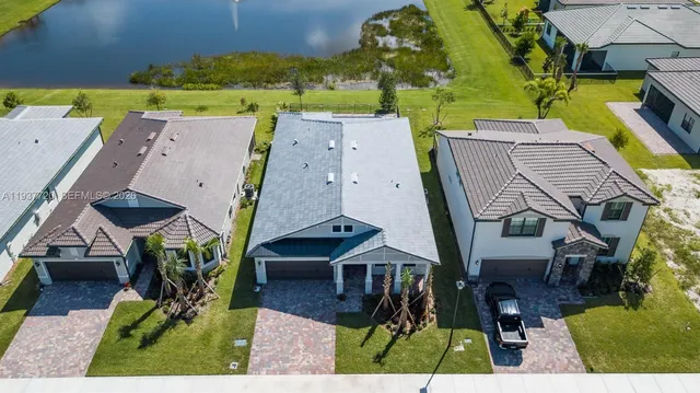 an aerial view of a residential houses with outdoor space