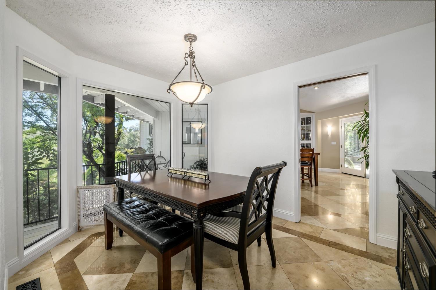 3165 Oakwood Road Cameron Park, CA 95682 - Photo 8 of 55 The formal dining room is enhanced by travertine flooring and picturesque views, creating the perfect setting for gatherings.