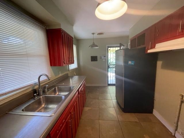 3300 Lucibill Road Memphis, TN 38116 - Photo 2 of 14 a kitchen with a sink a refrigerator and cabinets