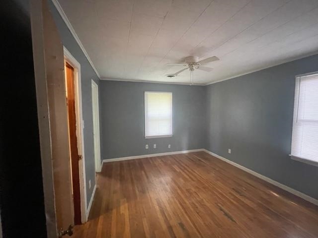 3300 Lucibill Road Memphis, TN 38116 - Photo 5 of 14 a view of an empty room with a window and wooden floor