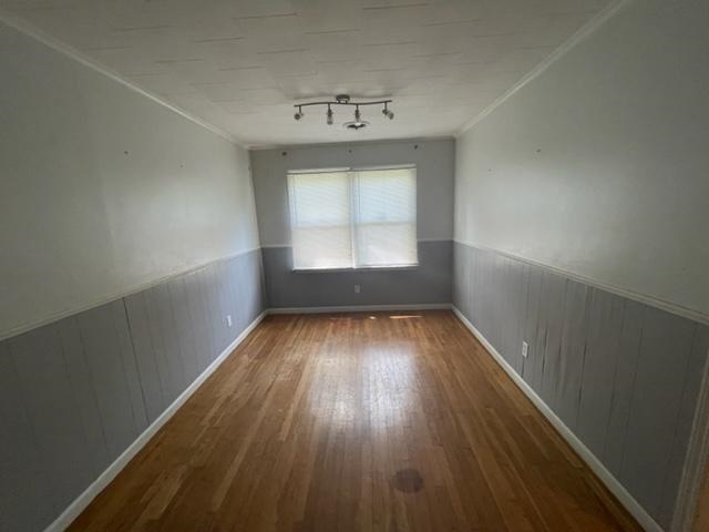 3300 Lucibill Road Memphis, TN 38116 - Photo 9 of 14 an empty room with wooden floor and windows
