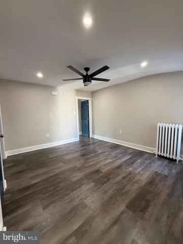 a view of a livingroom with a ceiling fan and wooden floor