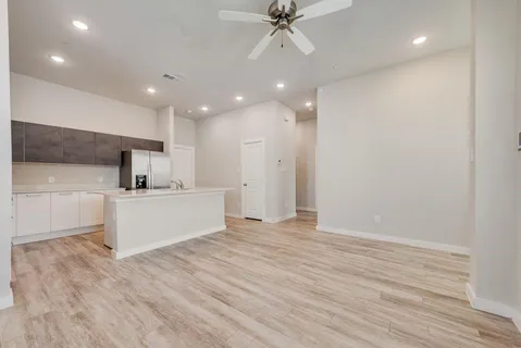 a view of kitchen with cabinets and wooden floor