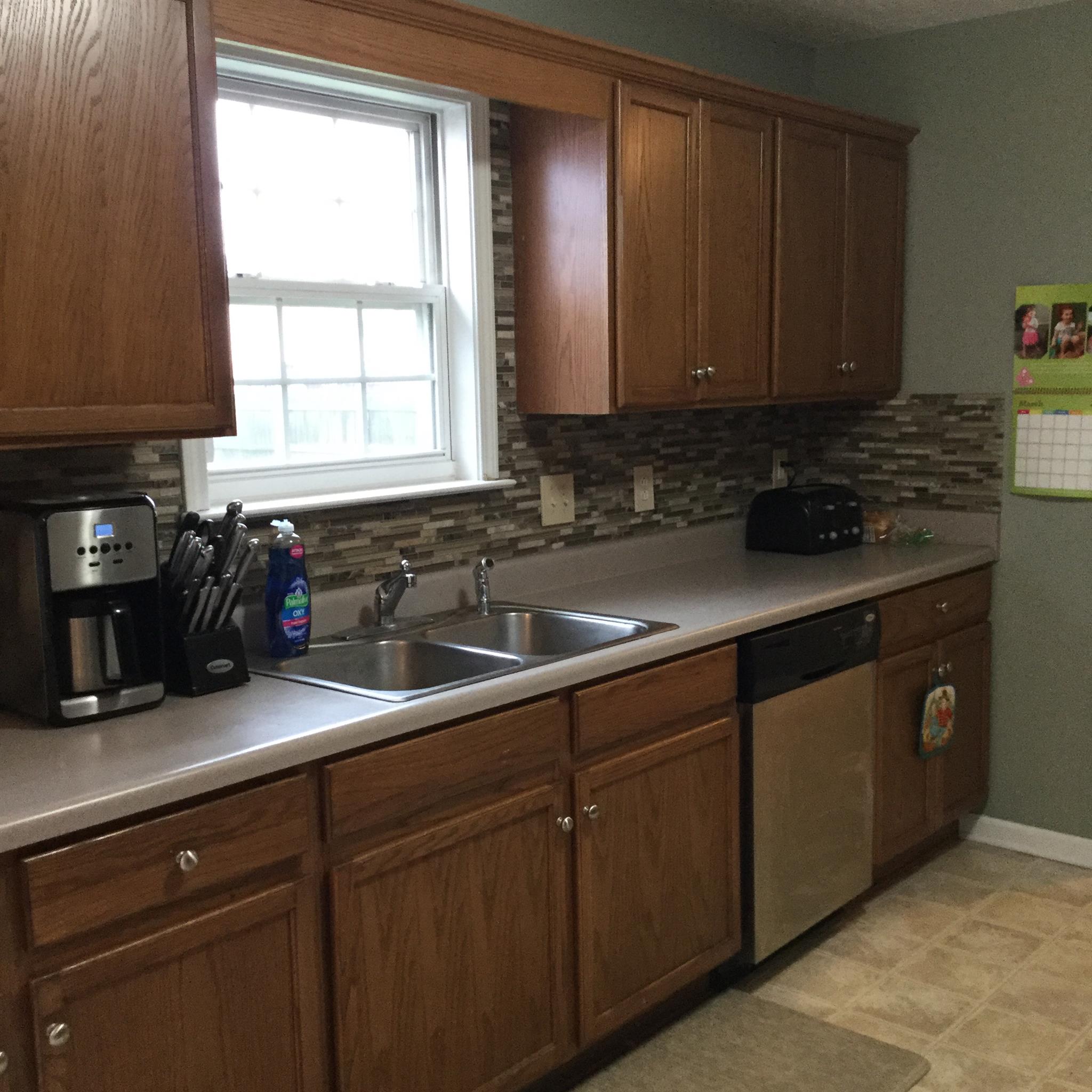 669 Crescent Road Murfreesboro, TN 37128 - Photo 11 of 16 a kitchen with stainless steel appliances granite countertop a sink a stove and cabinets