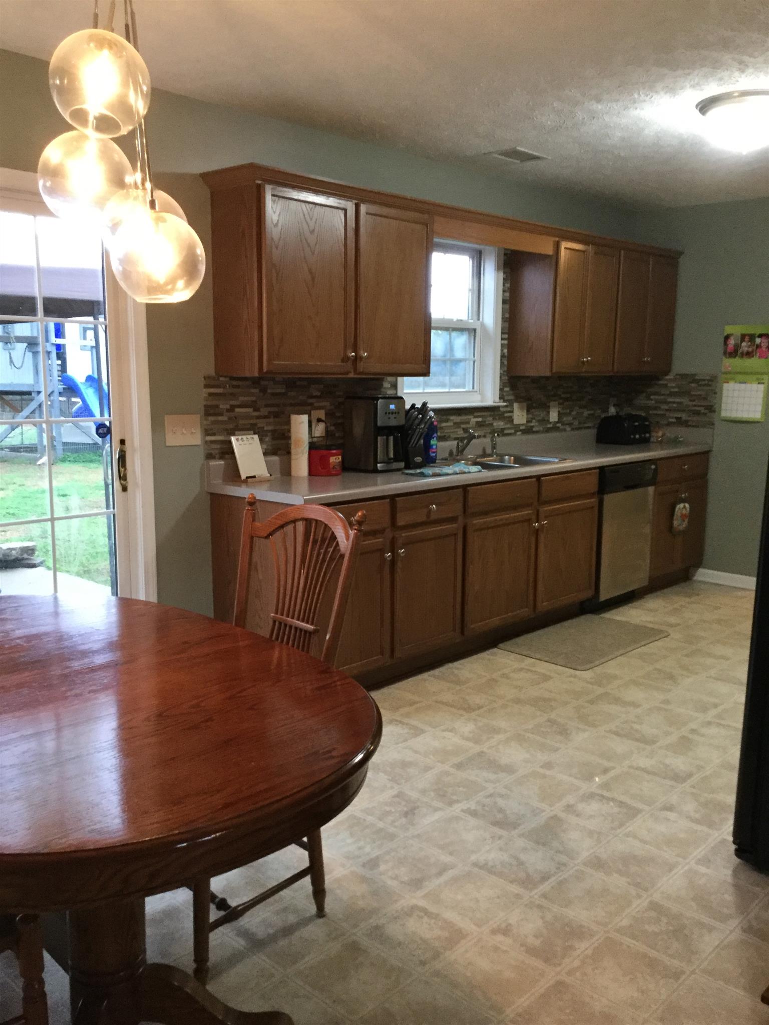 669 Crescent Road Murfreesboro, TN 37128 - Photo 12 of 16 a kitchen with stainless steel appliances granite countertop a sink dishwasher and a refrigerator with wooden floor
