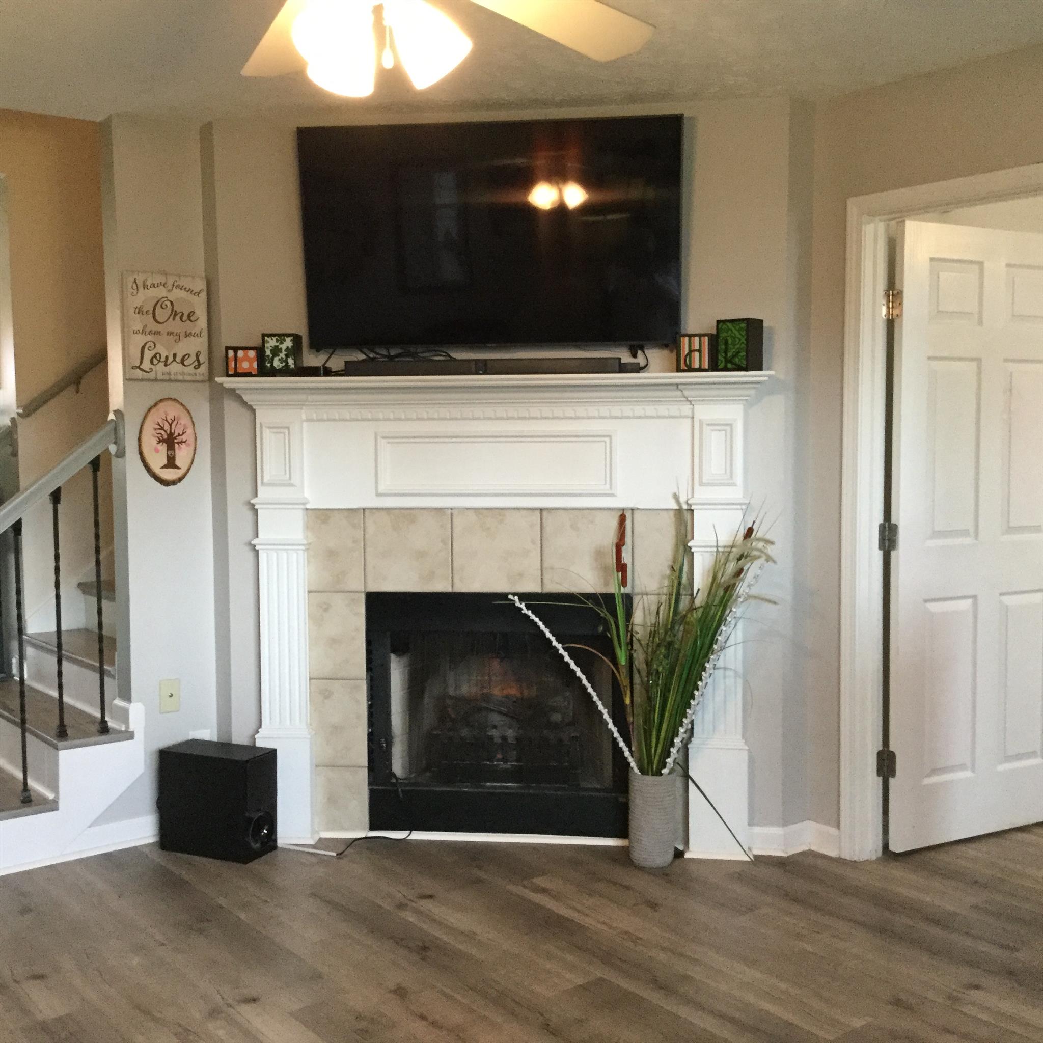 669 Crescent Road Murfreesboro, TN 37128 - Photo 16 of 16 a living room with a fireplace and a flat screen tv