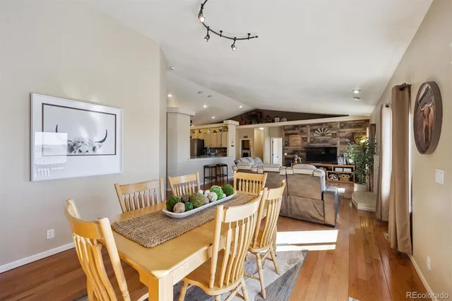 a view of a dining room with furniture wooden floor and chandelier