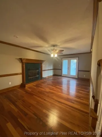 a view of empty room with wooden floor
