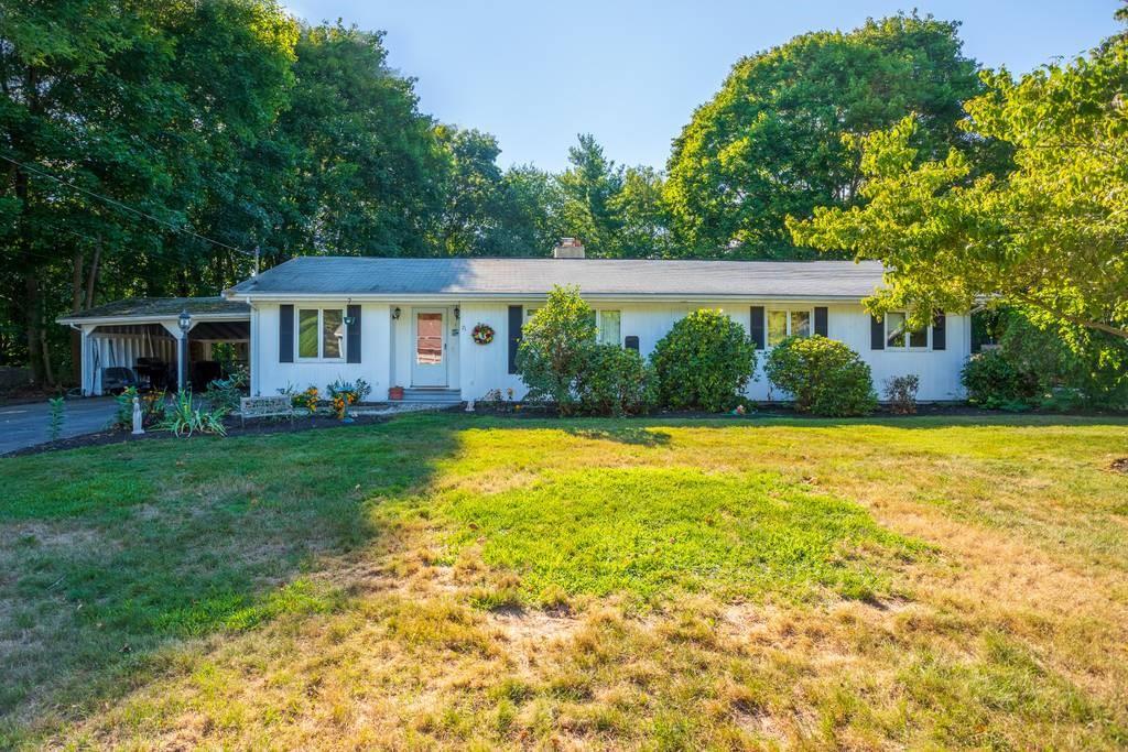 a front view of house with yard and green space