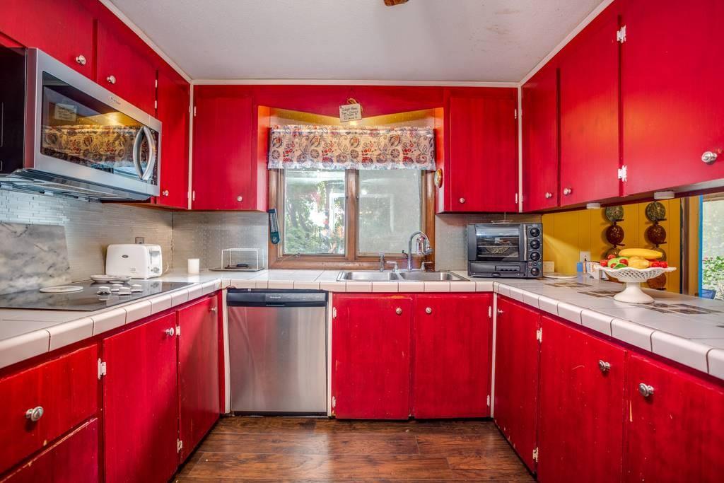 21 Tanner Road Webster, MA 01570 - Photo 12 of 26 a kitchen with stainless steel appliances a sink stove and wooden cabinets