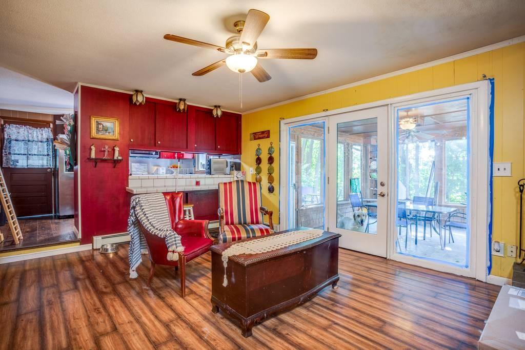 21 Tanner Road Webster, MA 01570 - Photo 15 of 26 a living room with furniture a flat screen tv and a floor to ceiling window