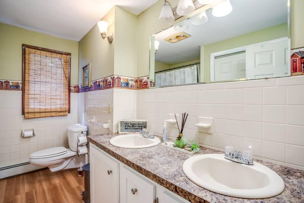21 Tanner Road Webster, MA 01570 - Photo 16 of 26 a bathroom with a granite countertop double vanity sink and a mirror