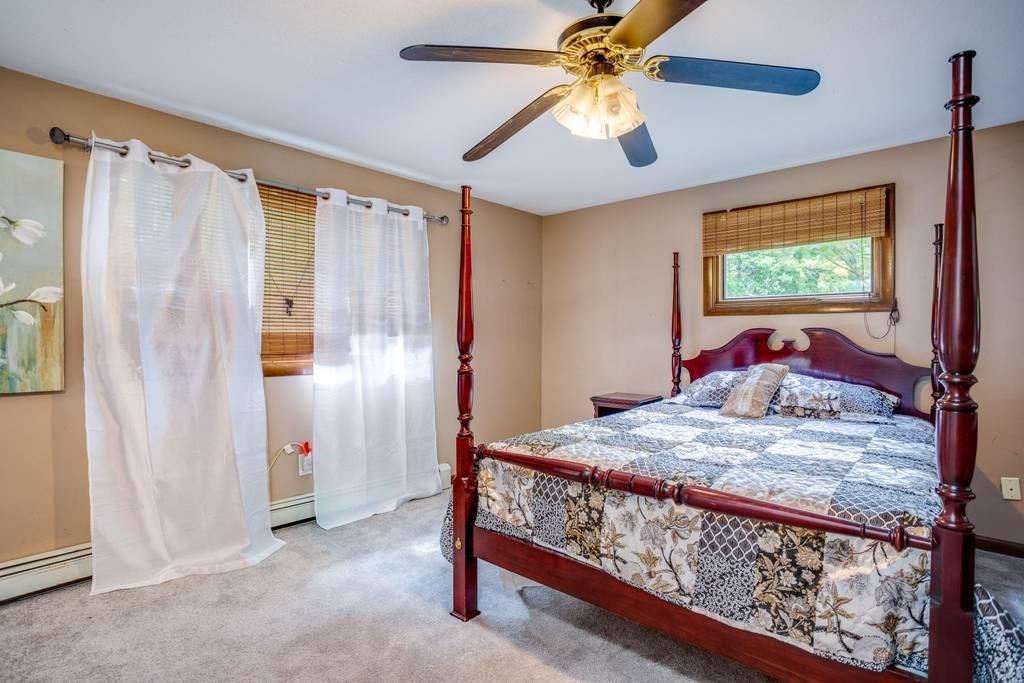 21 Tanner Road Webster, MA 01570 - Photo 17 of 26 a bed room with a bed and a chandelier