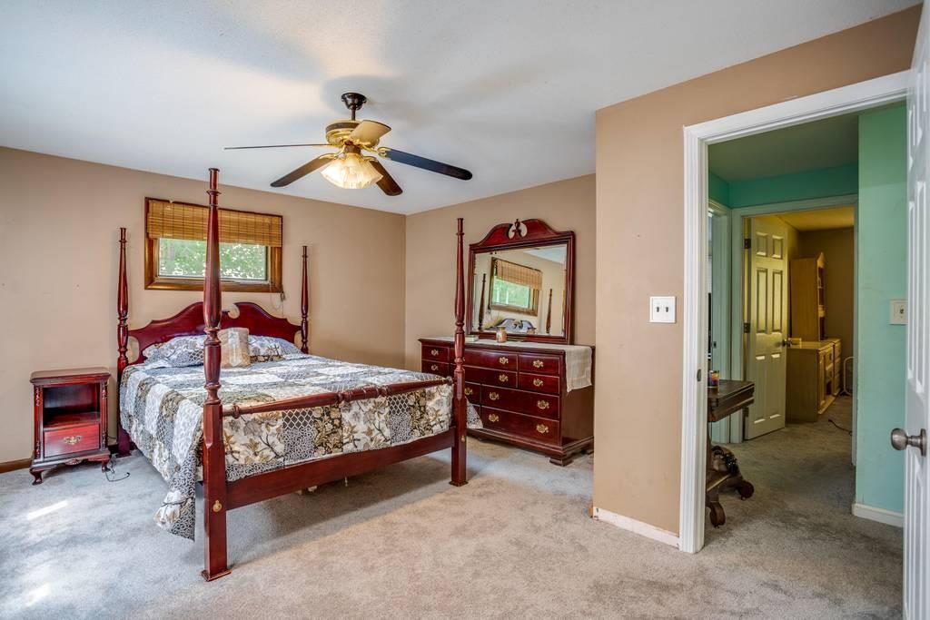 21 Tanner Road Webster, MA 01570 - Photo 18 of 26 a bedroom with a bed and a chandelier