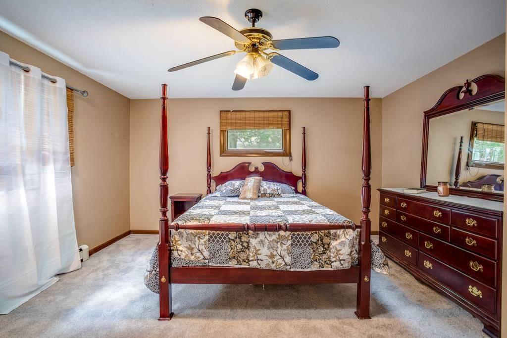 21 Tanner Road Webster, MA 01570 - Photo 19 of 26 a bedroom with a bed and a chandelier