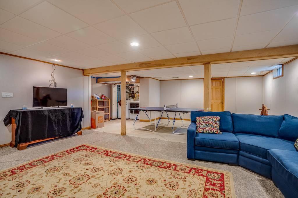 21 Tanner Road Webster, MA 01570 - Photo 26 of 26 a living room with furniture and a flat screen tv