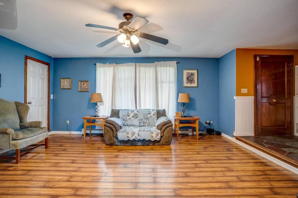 21 Tanner Road Webster, MA 01570 - Photo 9 of 26 a living room with furniture and a wooden floor
