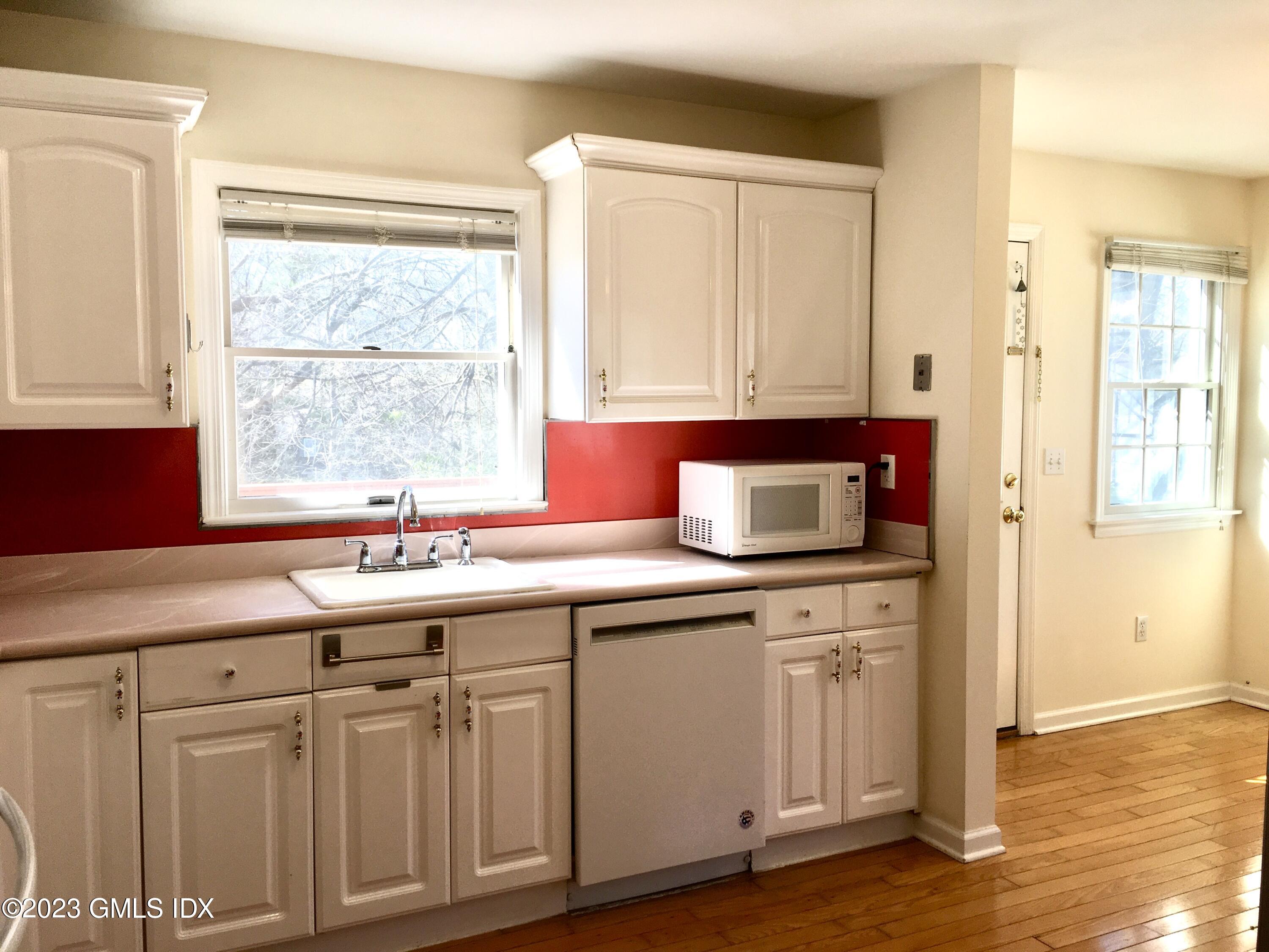 28 Wescott Street Riverside, CT 06878 - Photo 8 of 30 a kitchen with stainless steel appliances granite countertop a sink and a window