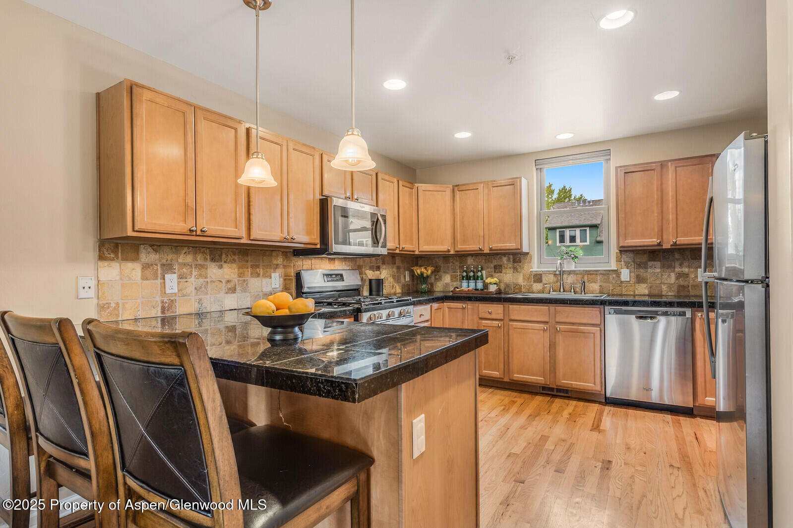 113 Lakeside Court Basalt, CO 81621 - Photo 8 of 39 a kitchen with kitchen island granite countertop a sink window and cabinets