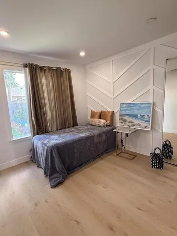 a bedroom with a bed and a window