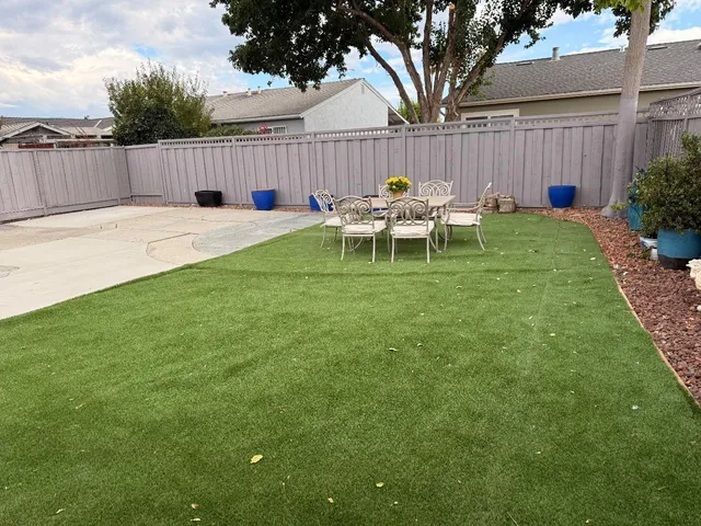 a swimming pool with outdoor seating and yard
