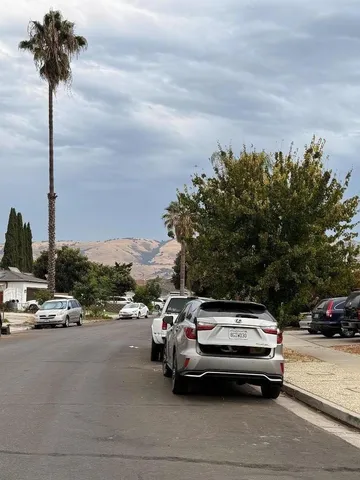 a view of street with parked cars
