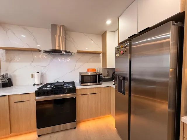 a kitchen with a refrigerator stove and sink