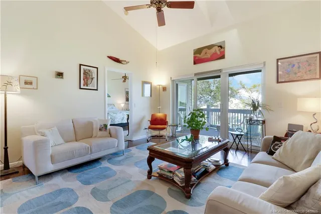 a living room with furniture and flowers
