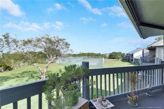 a view of roof deck with couch and wooden floor