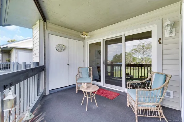 a bedroom with a bed and large windows