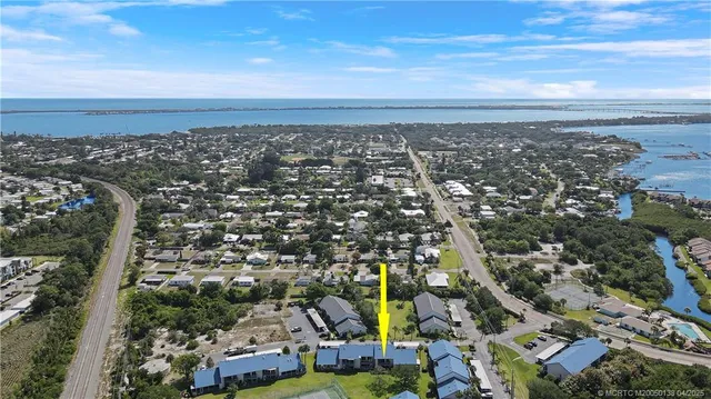 a view of a lake with couches chairs and wooden floor