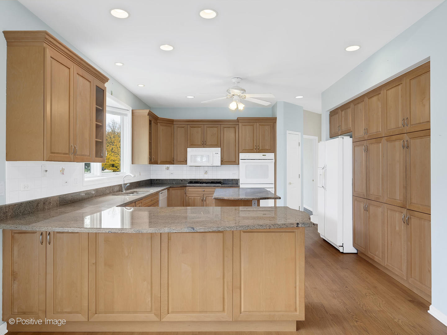 1332 Arbor Drive Lemont, IL 60439 - Photo 11 of 31 a large kitchen with stainless steel appliances granite countertop a refrigerator a sink dishwasher and white cabinets with wooden floor