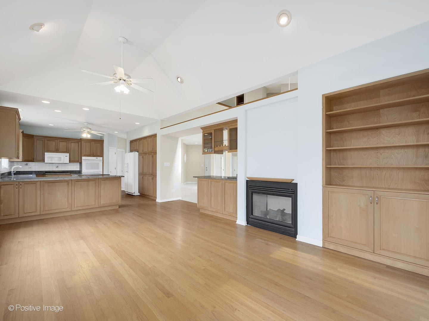 1332 Arbor Drive Lemont, IL 60439 - Photo 12 of 31 a view of kitchen and empty room with wooden floor and kitchen