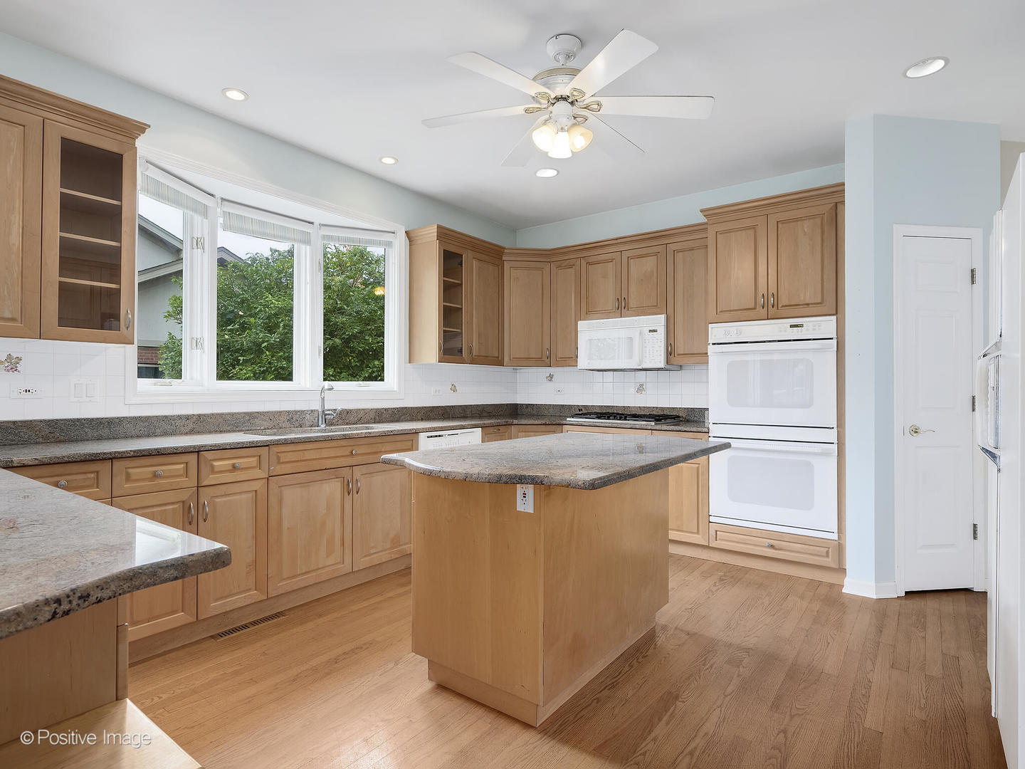 1332 Arbor Drive Lemont, IL 60439 - Photo 10 of 31 a kitchen with stainless steel appliances granite countertop a stove a sink and a refrigerator