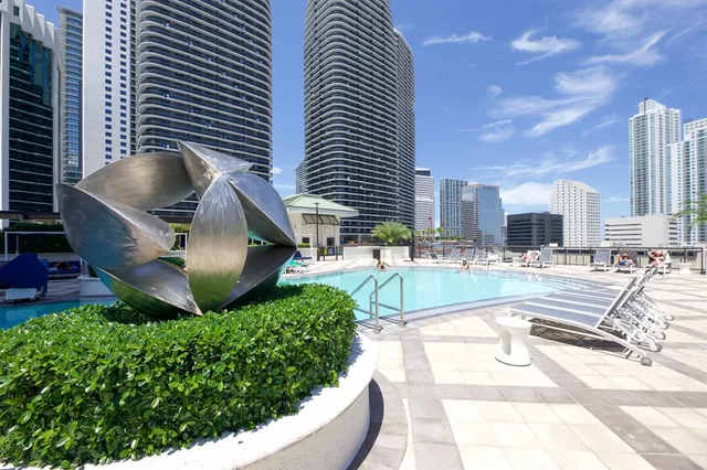 a swimming pool with outdoor seating and yard