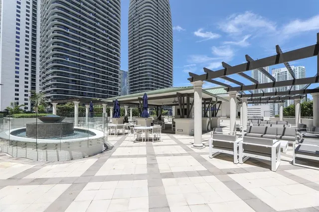 a building outdoor space with patio furniture and potted plants